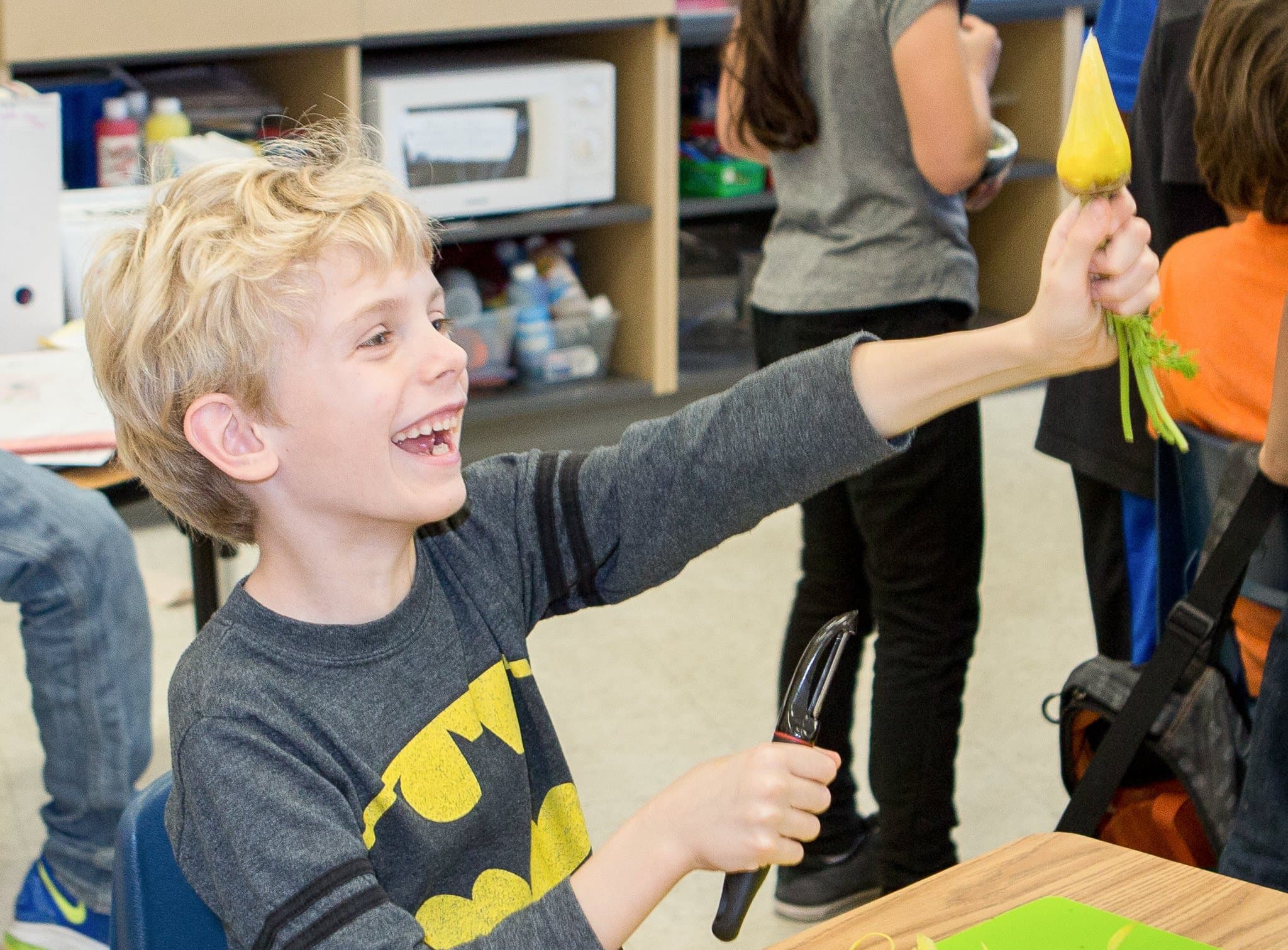 Smiling woman giving a piggyback ride to a laughing young girl.